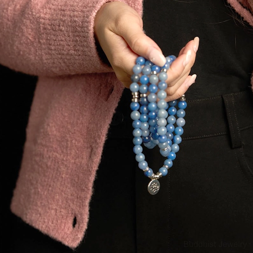 Blue aventurine multi-layer mala bracelet hanging vertically from fingers side view