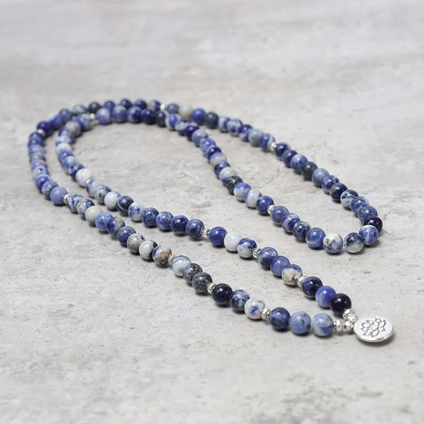 Long blue aventurine necklace strand with lotus silver charm overhead view