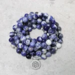 Blue aventurine lotus mala bracelet coiled beads with sterling silver charm top-down view