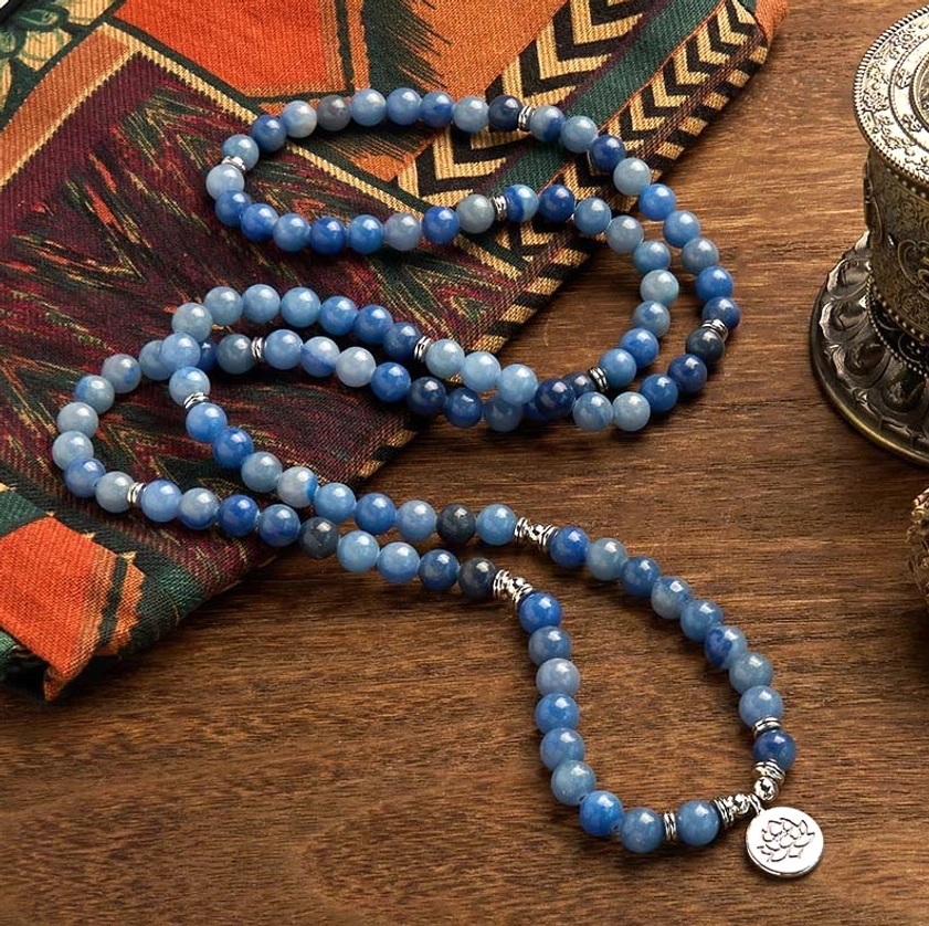 Natural blue aventurine 108 mala prayer beads with silver metal spacers and lotus charm overhead view