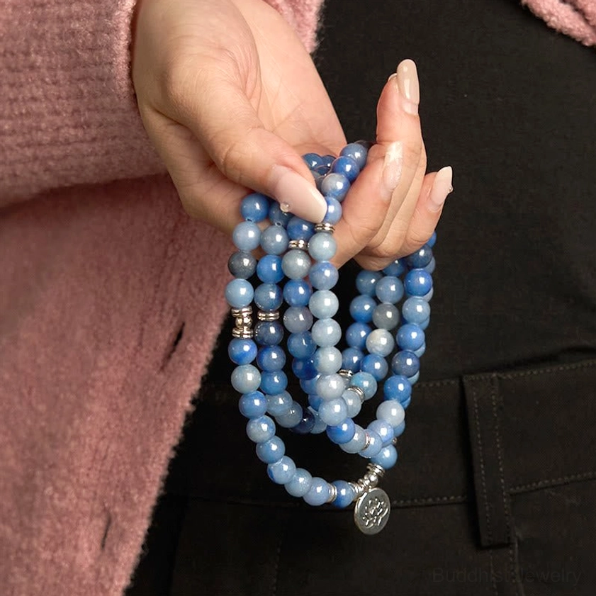 Blue aventurine 108 mala bracelet with silver lotus pendant close-up grip in hands