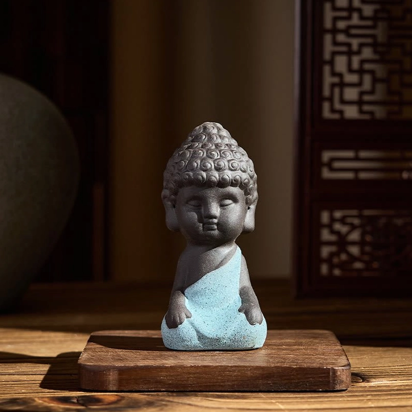 Blue robed Buddha statue seated with hands on knees, natural purple clay mindfulness decoration