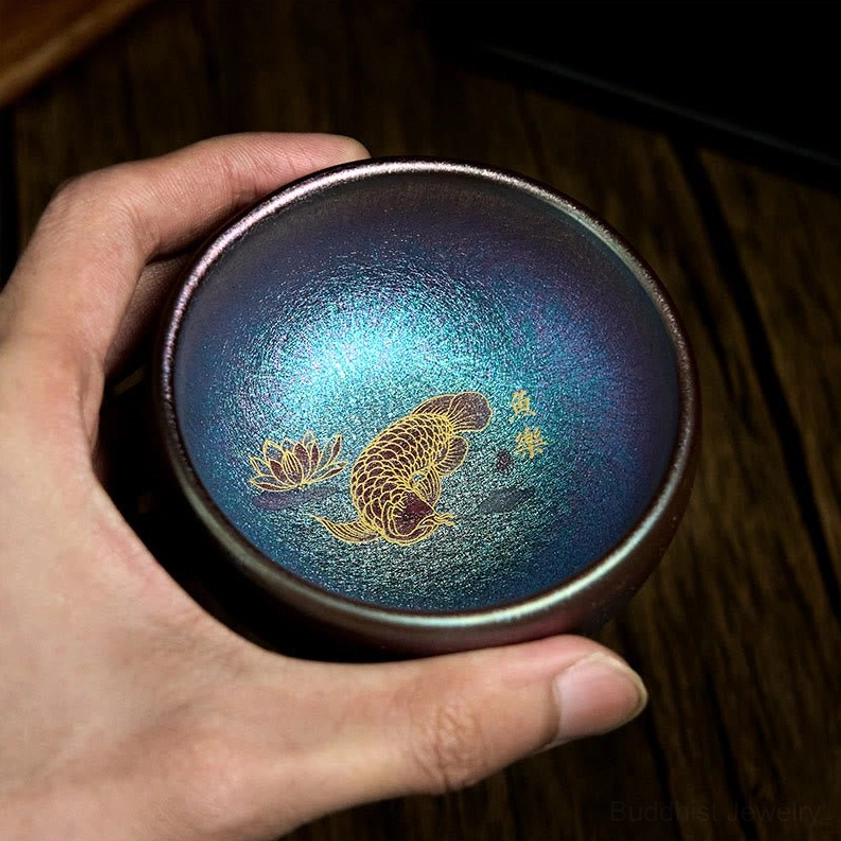 Blue gold koi fish lotus tea cup handmade Jianzhan ceramic top-down view showing inner pattern