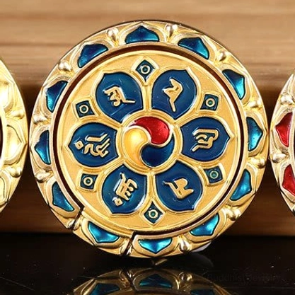 Blue and gold six-character mantra phone ring holder, blending traditional Buddhist symbolism with modern functionality