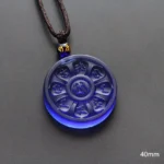 Blue Liuli Manjusri Buddhist necklace pendant with carved mantras flat lay view showing 40mm size