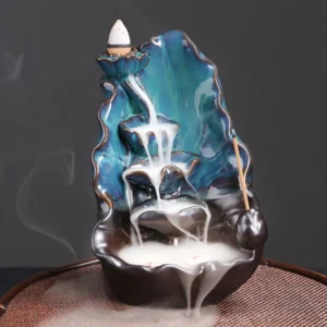 Blue lotus leaf ceramic backflow incense burner front three-quarter view showing teal and dark brown glazed ceramic with flowing smoke effect