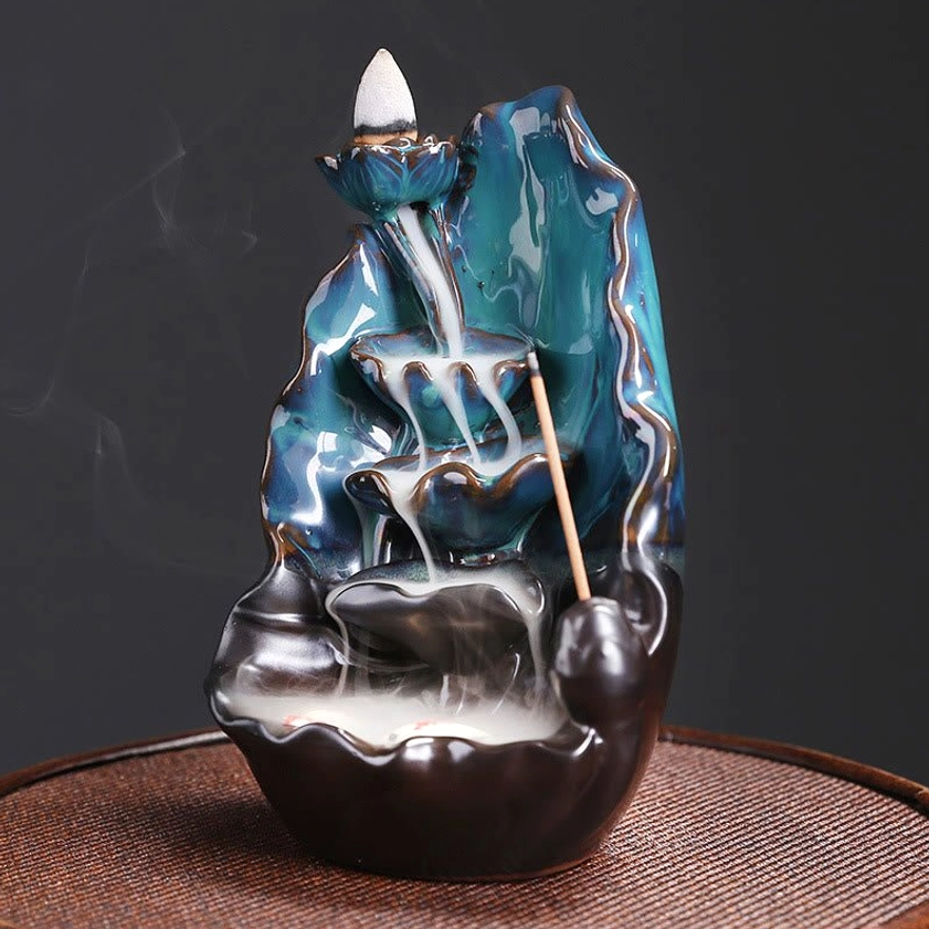 Right side front three-quarter view of blue lotus backflow incense burner showing detailed lotus leaf structure and flowing smoke