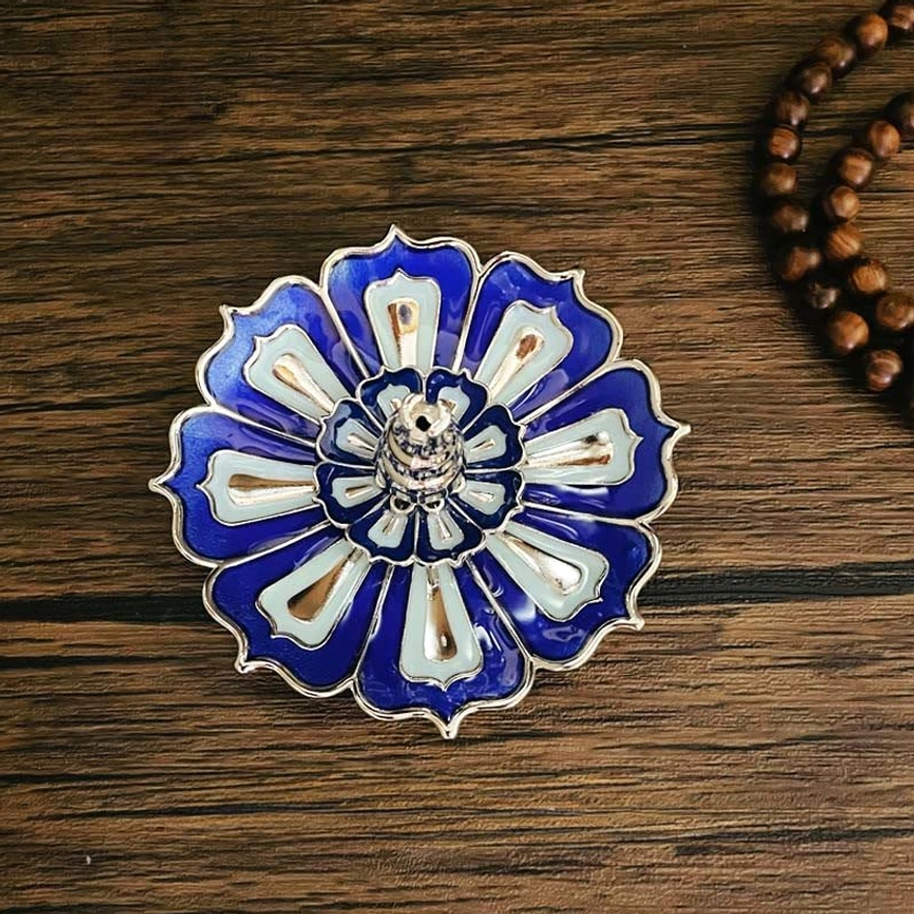 Blue and off-white lotus-shaped incense holder with silver trim for meditation and spiritual practice