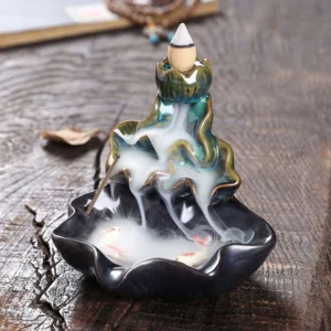 Blue lotus koi ceramic backflow incense burner with flowing smoke on wooden surface
