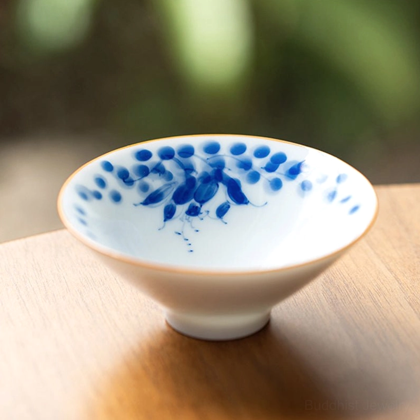 Blue lotus flower porcelain teacup Buddhist symbolism hand-painted ceramic pod design