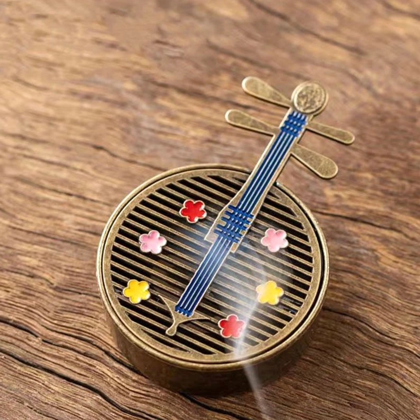 Blue pipa incense burner with flower inlays and fan vents releasing incense smoke