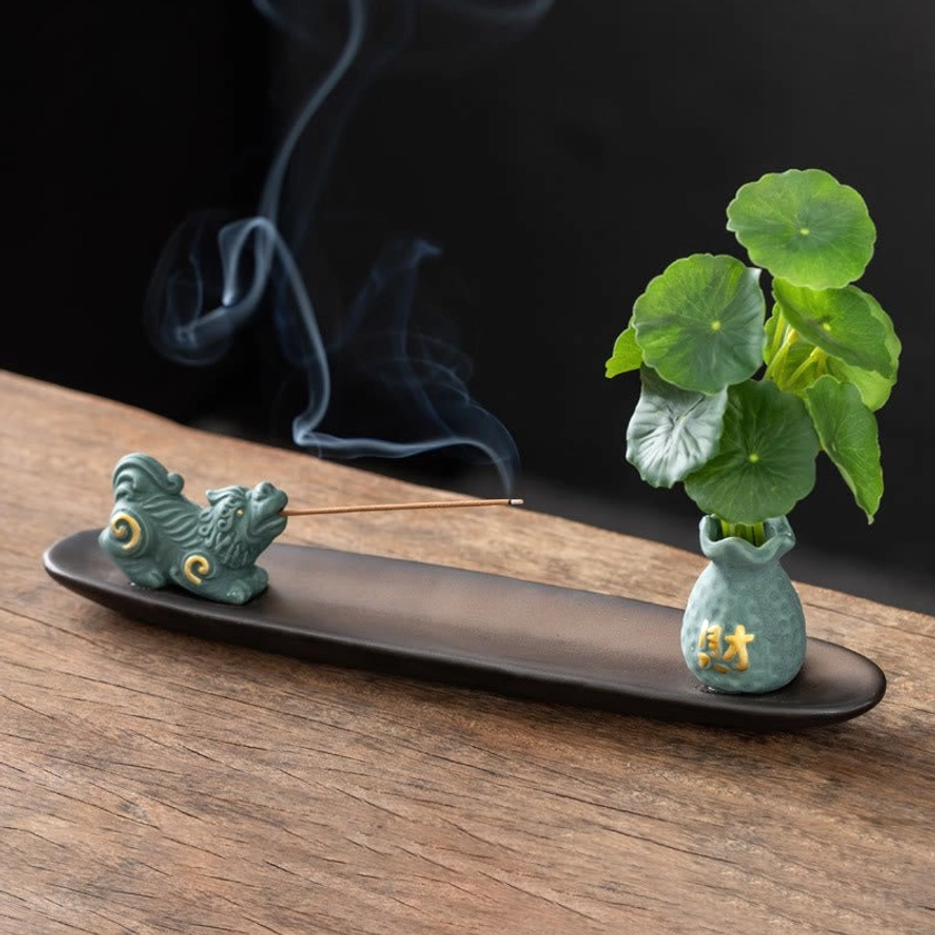 Blue Pixiu wealth protection ceramic incense burner with figurine and vase on wooden table