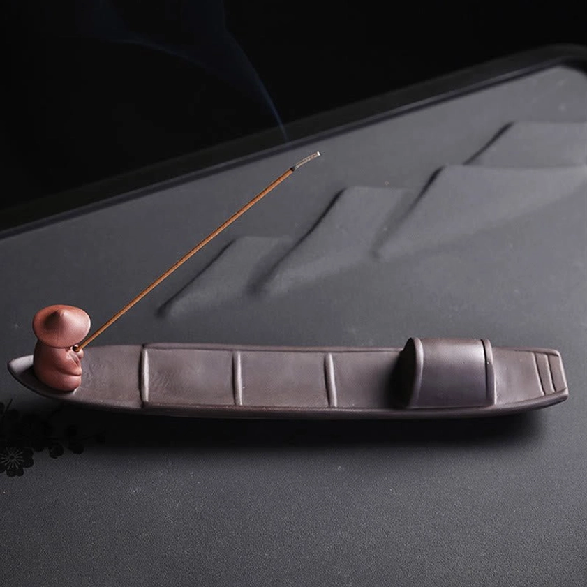 Segmented long boat purple clay incense holder, front profile view showcasing matte ceramic finish and handcrafted boat deck design for meditation practice