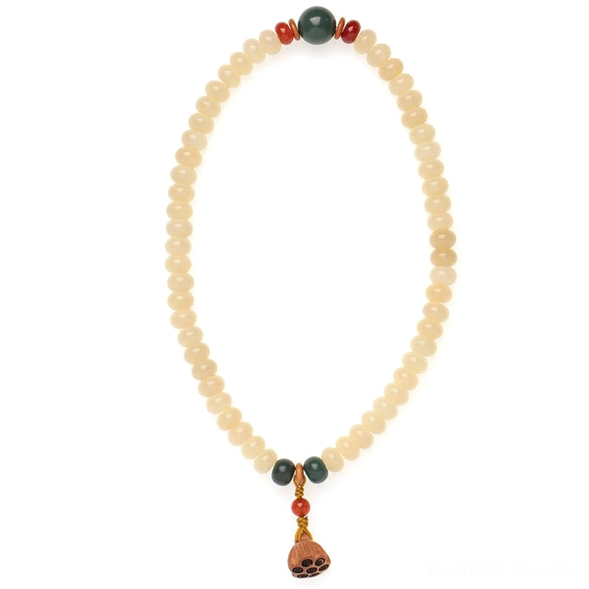 Bracelet pendant assembly detail showing green matte bead, red beads, and wooden spacers