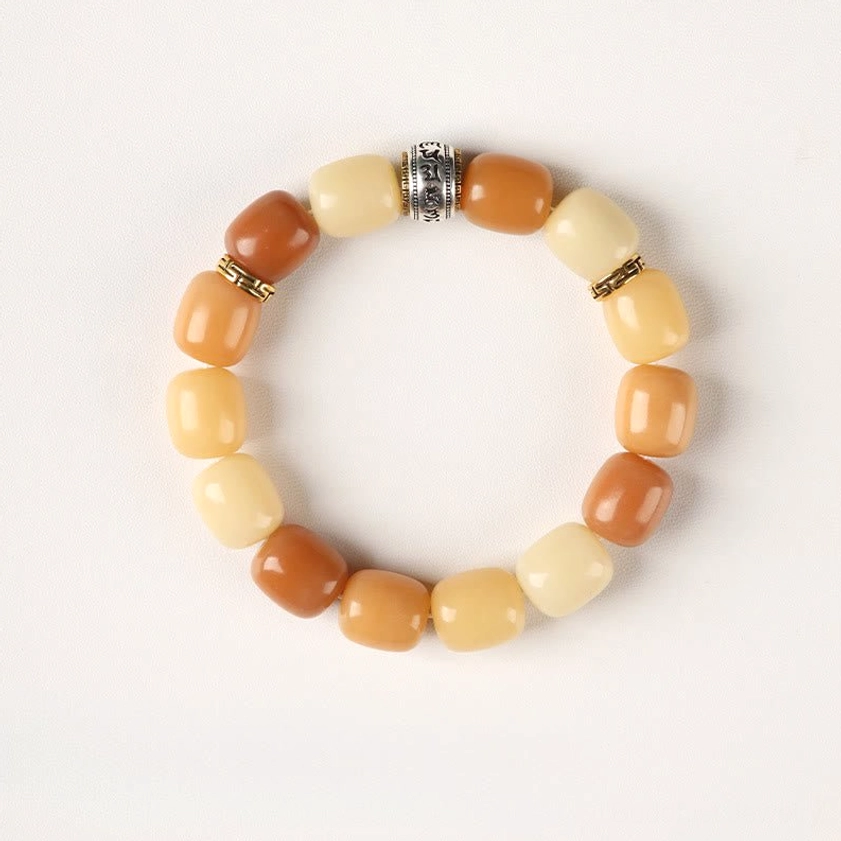 Two-tone bodhi seed bracelet with alternating caramel and cream beads and buddhist metal accents