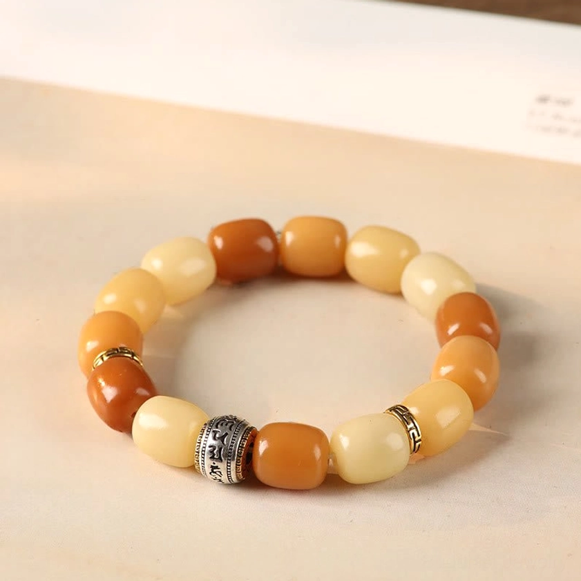 Bodhi seed bracelet in warm caramel and cream tones with silver engraved metal spacer