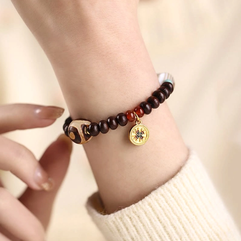 Buddhist bodhi seed bracelet styled on wrist with knitted sweater, showing comfortable fit and elegant design