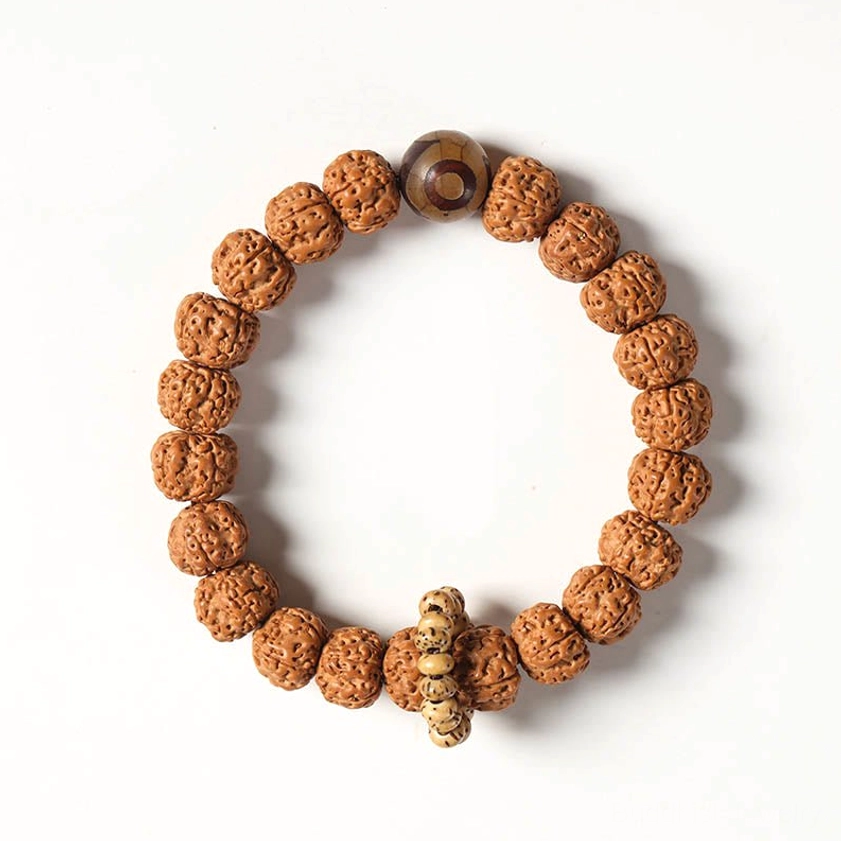 Natural bodhi seed Buddhist bracelet with three-eye Dzi bead and jade accent showing traditional materials