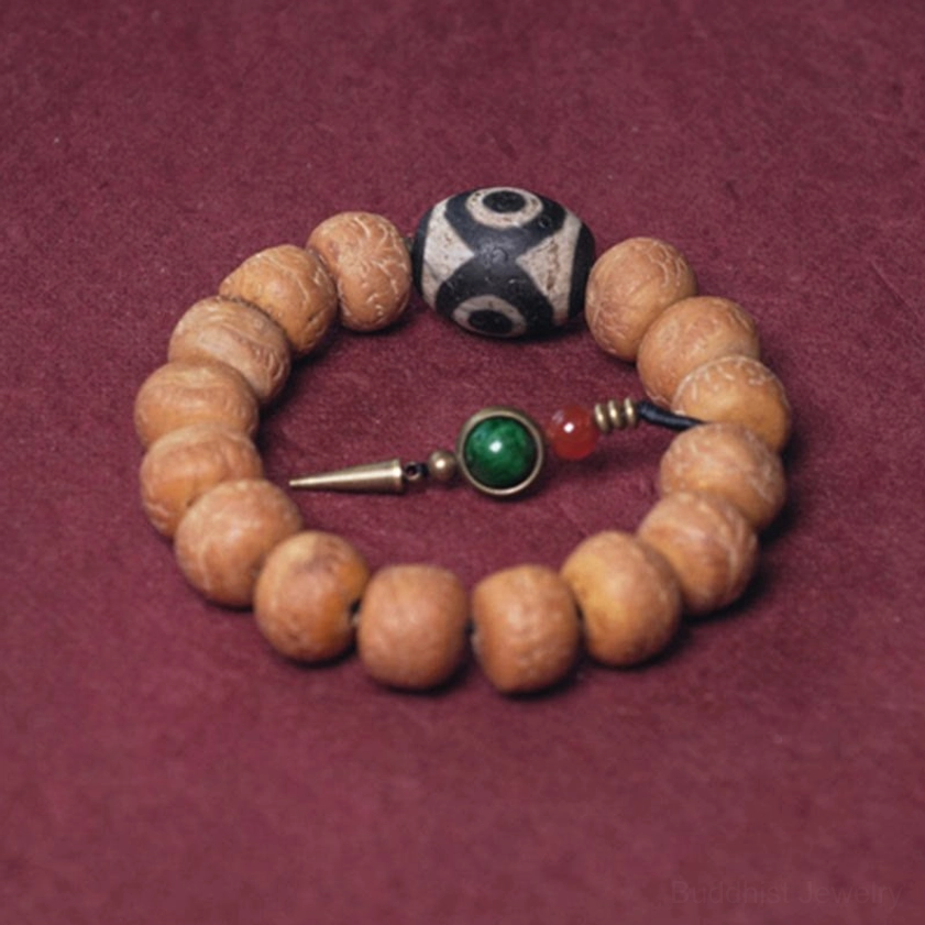 Buddhist mala bracelet with bodhi beads, three-eye dzi bead, and green-red tassel pendant