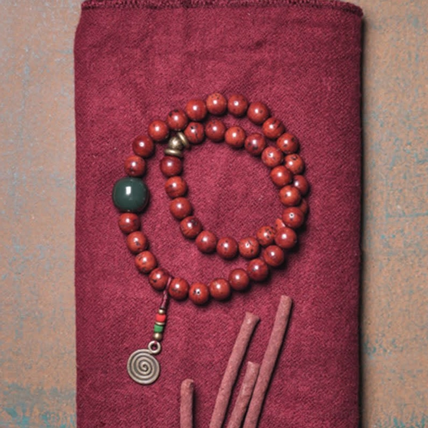 Handcrafted bodhi seed jade copper bracelet flat lay with incense sticks spiritual scene