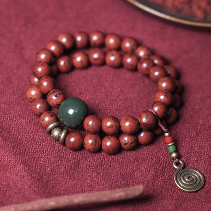 Bodhi seed cyan jade double-loop bracelet with incense near spiral pendant spiritual practice