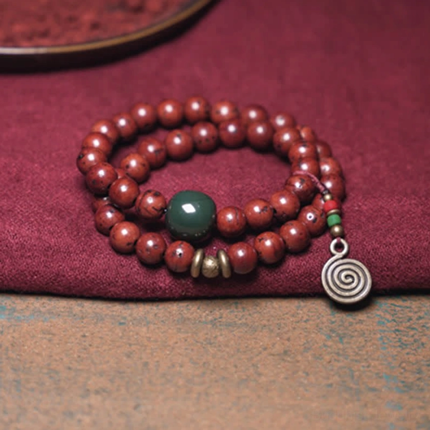 Double-loop bodhi seed cyan jade bracelet with spiral pendant and dark green accent bead