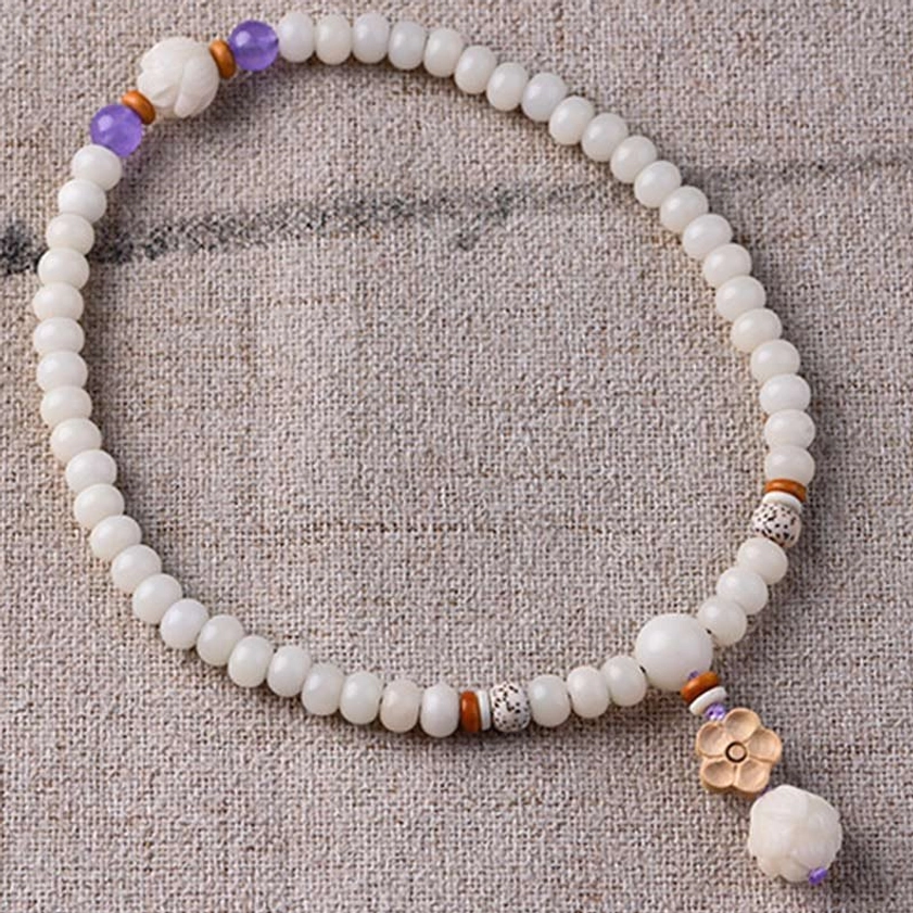 Buddhist meditation bracelet with bodhi seeds and lotus charm in gift packaging