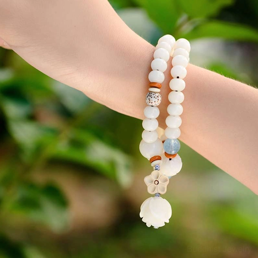 Spiritual bodhi lotus blessing bracelet worn on wrist with natural leaf backdrop