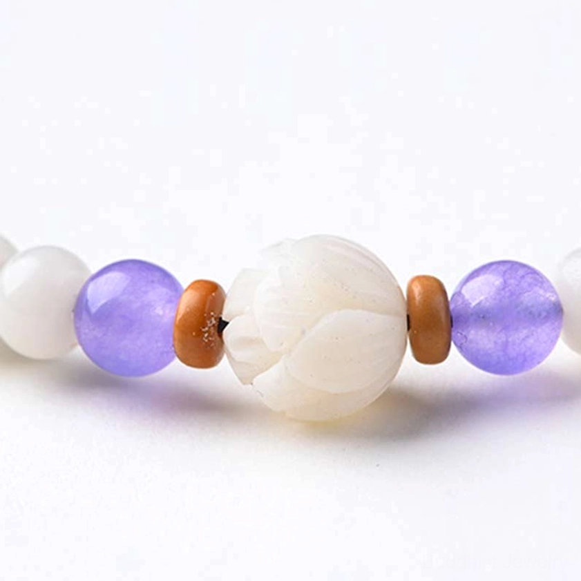 Buddhist bodhi bracelet with lotus pendant and aquamarine beads close-up photography