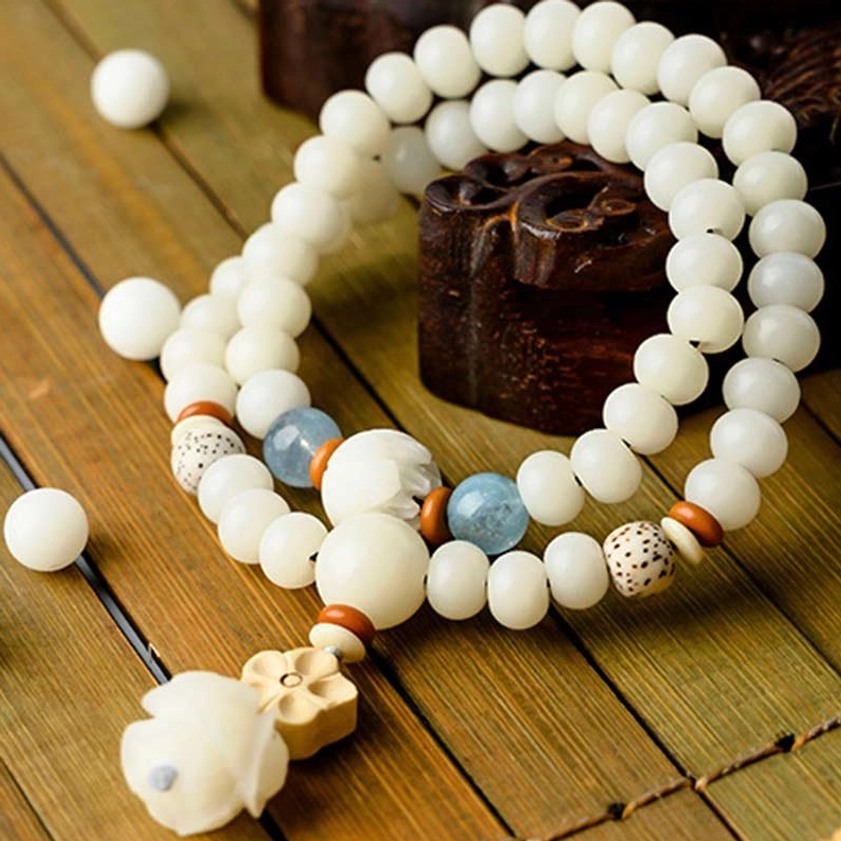 Double-loop bodhi lotus bracelet angled view showcasing aquamarine and boxwood spacers