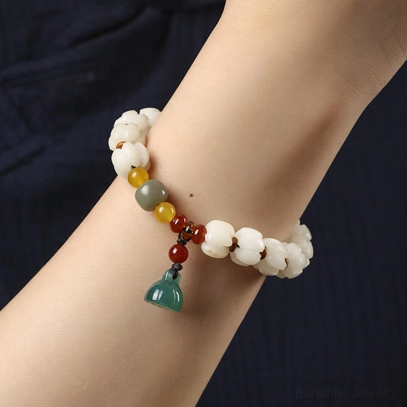 Buddhist bodhi bracelet on wrist with green lotus charm close-up shot of wearing style