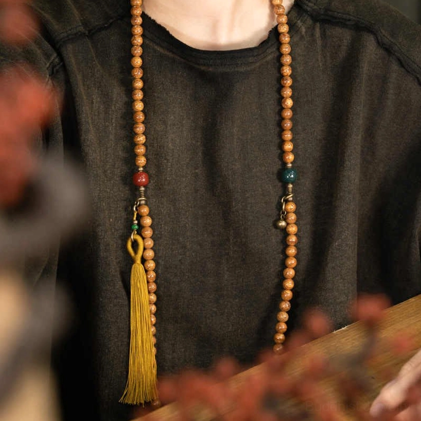 Bodhi seed meditation mala worn on chest with jade and cinnabar accent beads