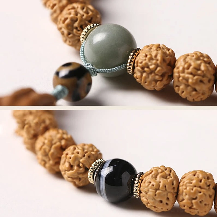 Bodhi seed mala bracelet with three-eye Dzi bead and Buddha hand charm showing handmade artisan craftsmanship