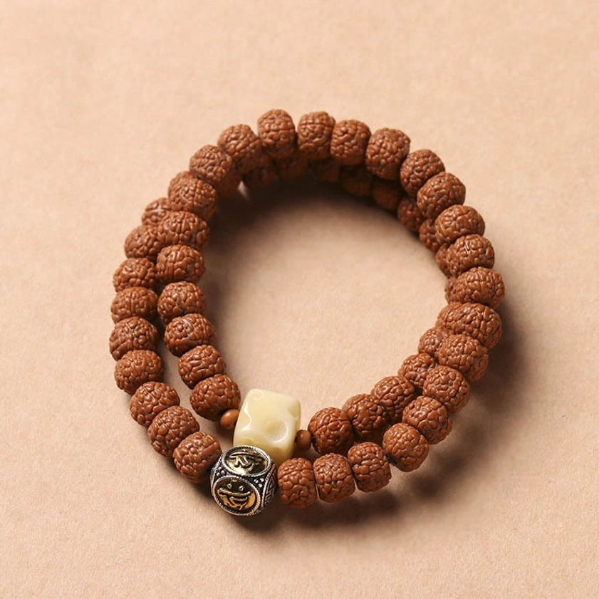 Bodhi seed mala bracelet with dragon scale pattern accents and three-eye Dzi bead for protection
