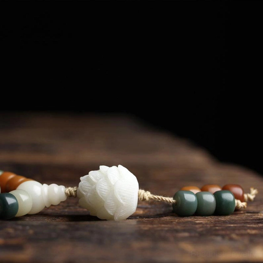 Large carved white lotus bead detail of bodhi mala pendant with dark green jade accents