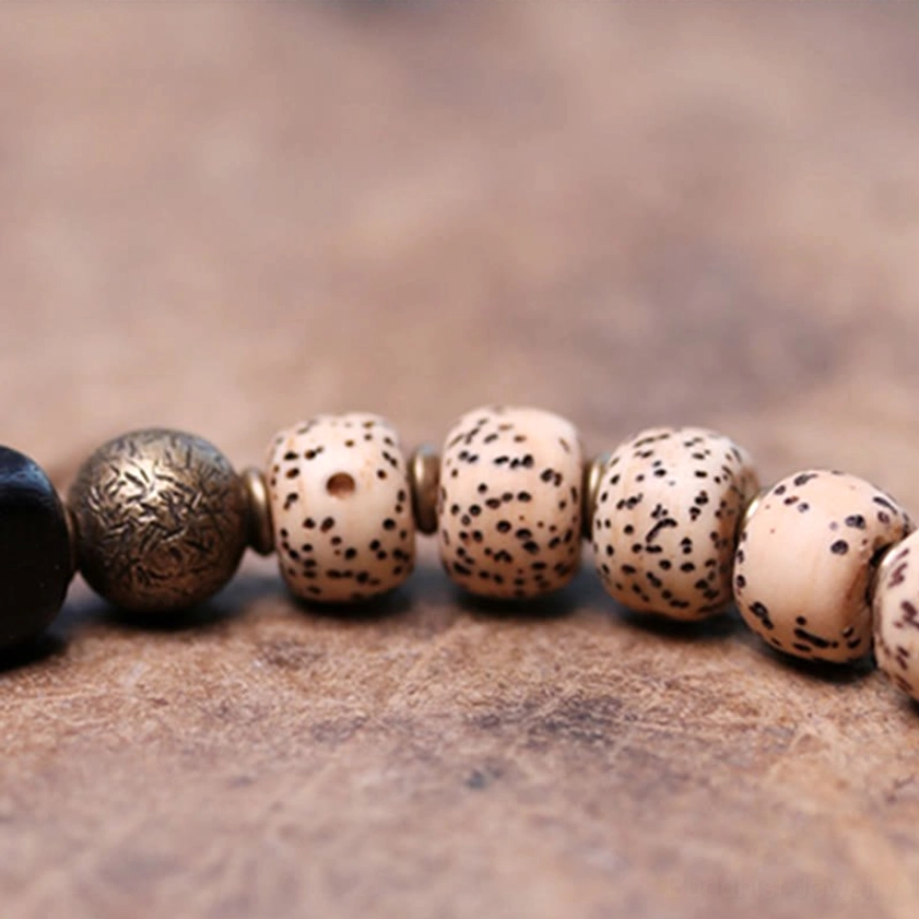 Handcrafted bodhi seed black obsidian ebony wood Buddhist bracelet close-up detail shot