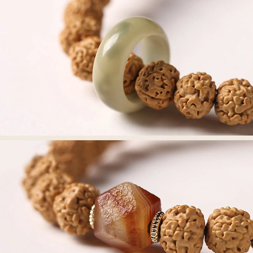 Natural bodhi seed Buddhist prayer bracelet with protective Dzi bead and spiritual accents displayed on dark background
