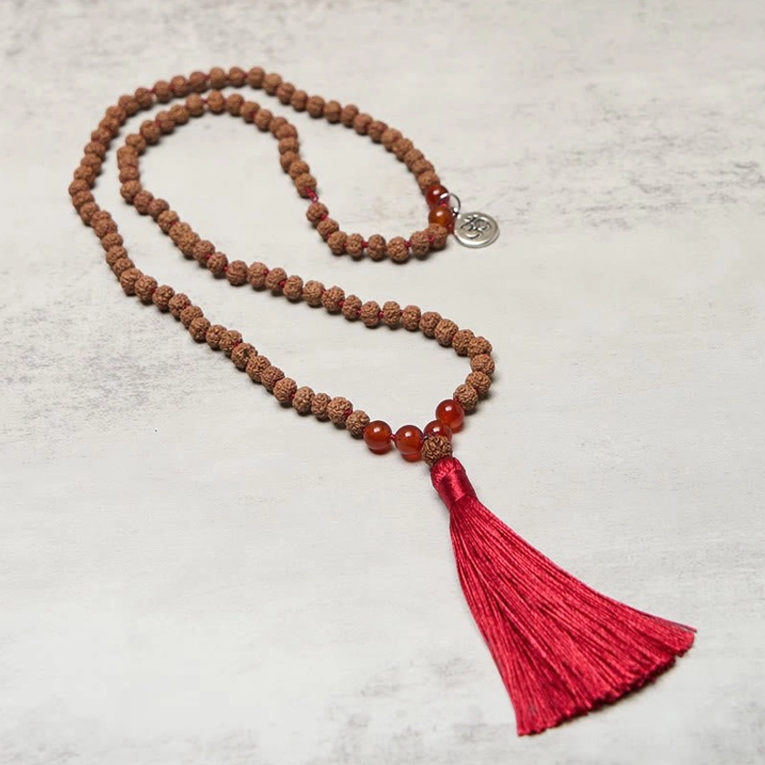 Long bodhi seed mala necklace angled view showing complete strand with red agate spacer beads and charm