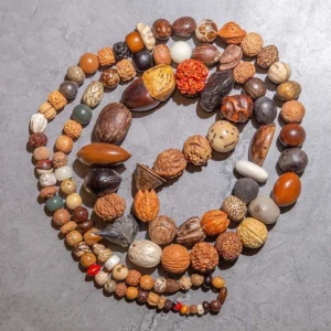 Authentic bodhi seed 108 mala beads Buddhist prayer bracelet with natural brown seed beads and colorful accent beads flat lay view