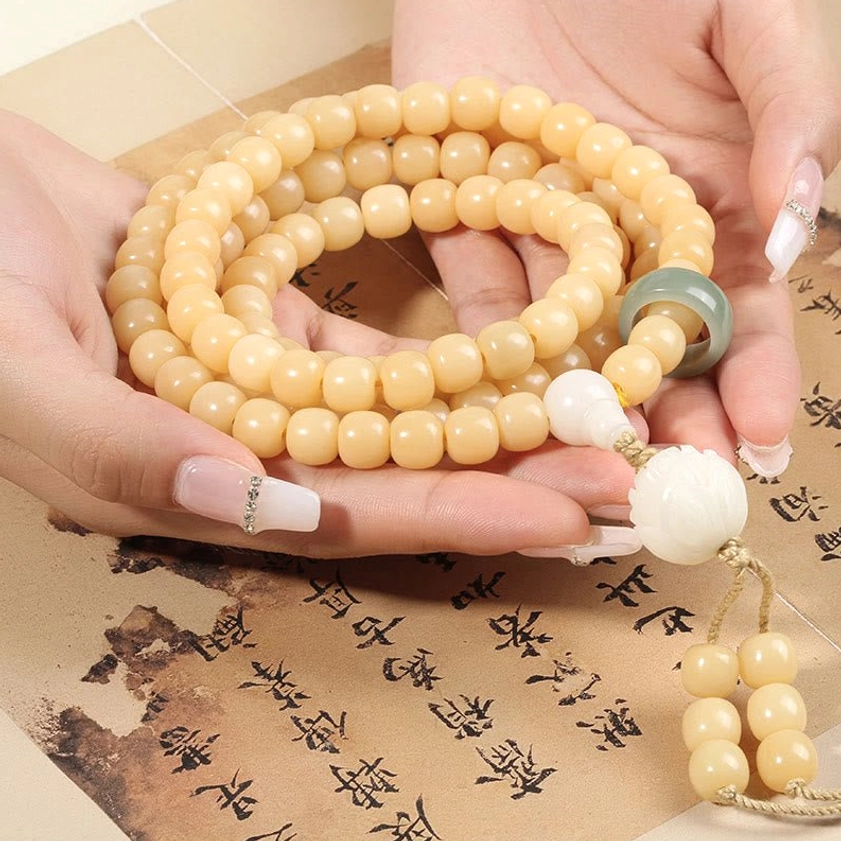 Unfurled 108 Bodhi Seed Mala Prayer Beads overhead view with jade ring and lotus tassel