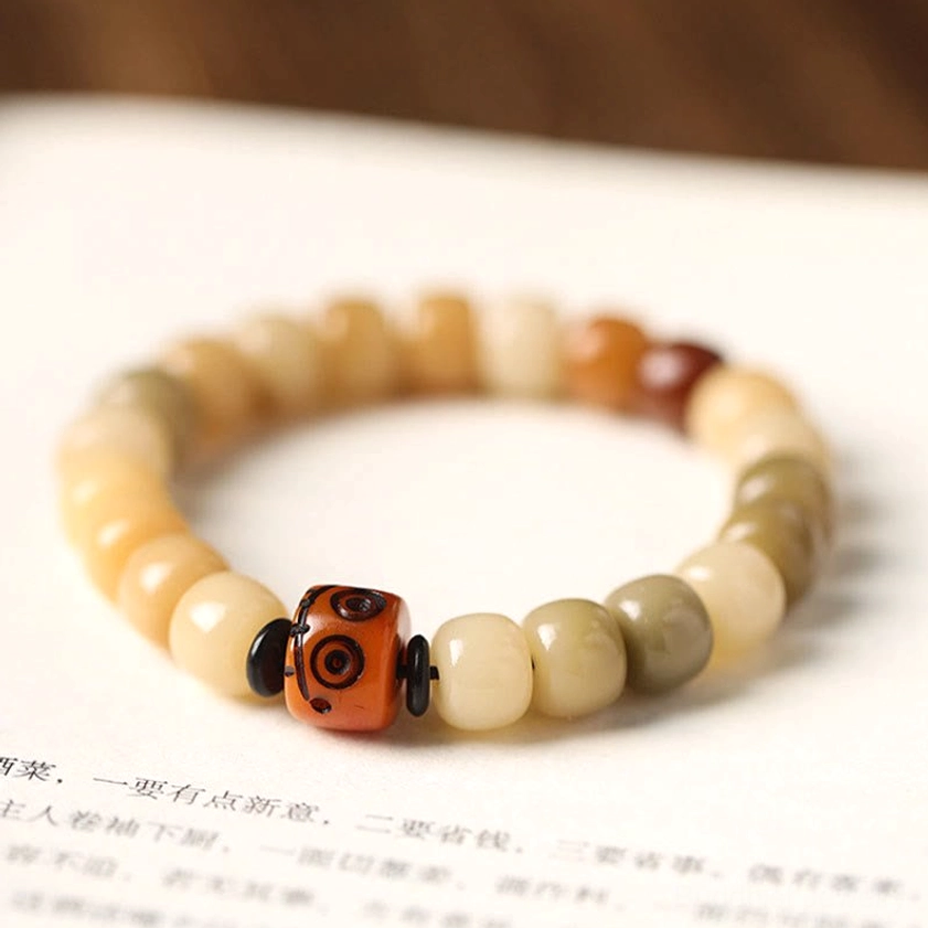 Bodhi seed wisdom bracelet close-up detail showing natural dark-speckled bead texture, barrel bead composition and elastic band construction
