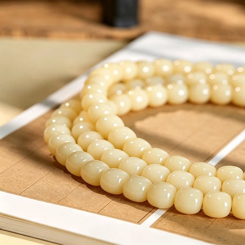 Uniform hand-polished bodhi seed beads in smooth creamy finish, detailed strand view