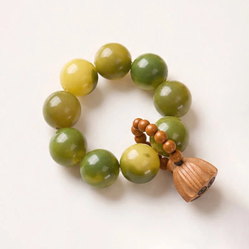 Polished bodhi seed beads and wooden lotus pendant showing natural material quality and craftsmanship
