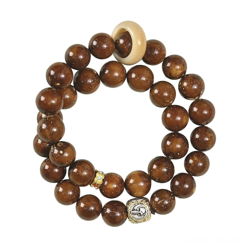 Double wrap bodhi seed bracelet flat lay with engraved metal charm and natural bone ring spacer