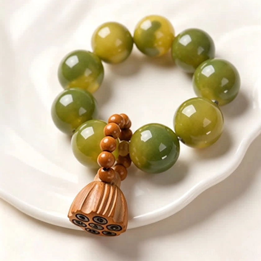 Bodhi seed lotus meditation bracelet in hand showing tactile grounding and portable zen tool