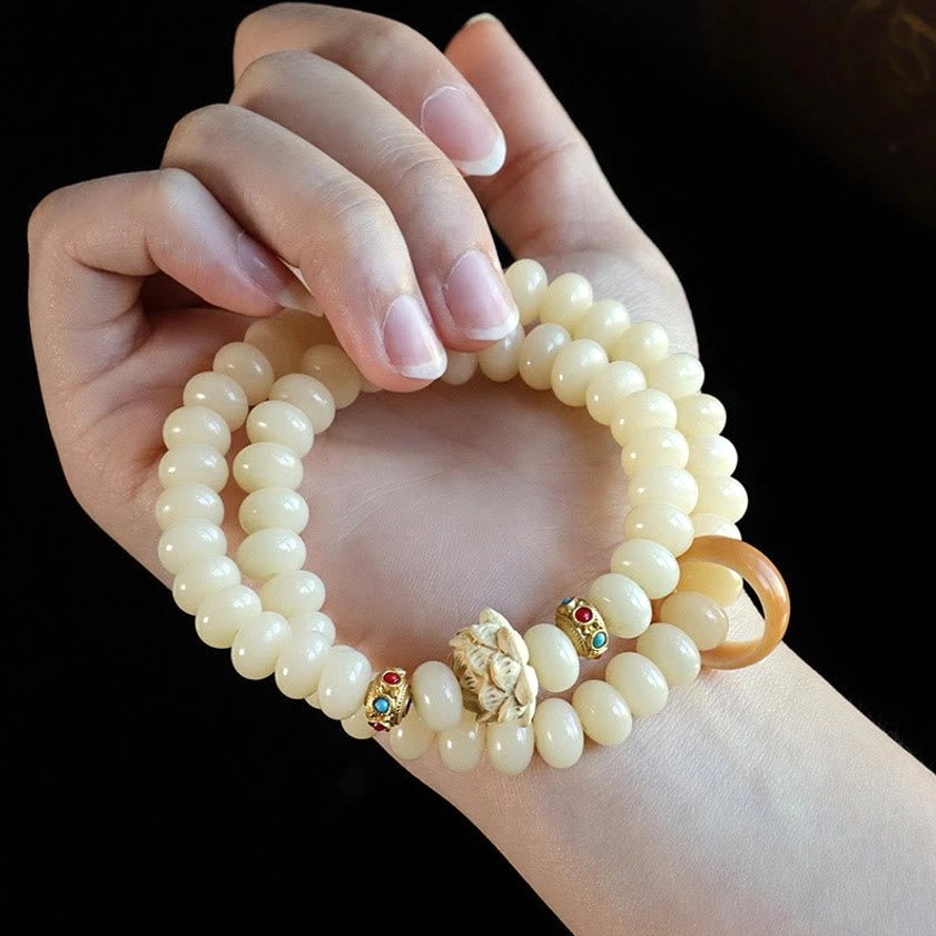 Hand-held bodhi seed peach wood bracelet - first person view showing how to wear the double wrap Buddhist bracelet