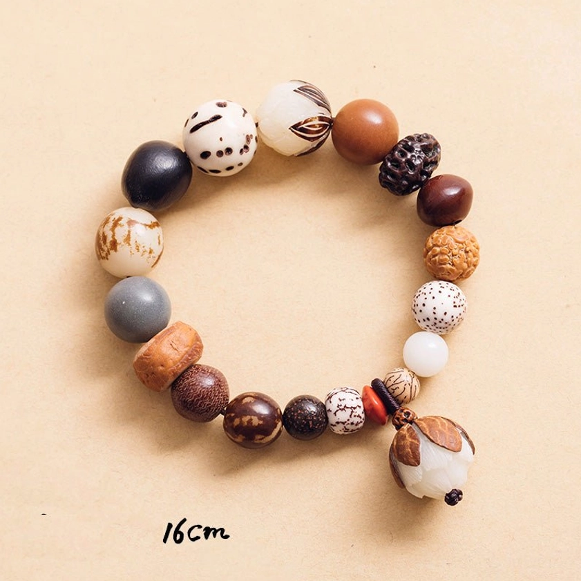 Bodhi seed bracelet 16cm size flat lay with lotus pendant on neutral background