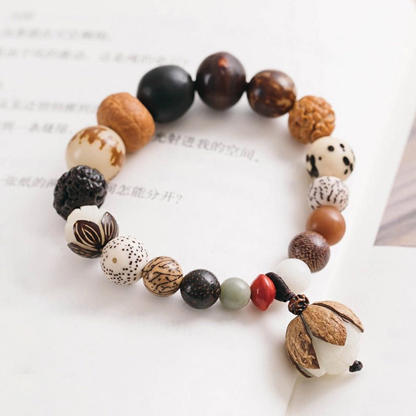 Handcrafted bodhi seed bracelet showing natural bead texture and lotus accent