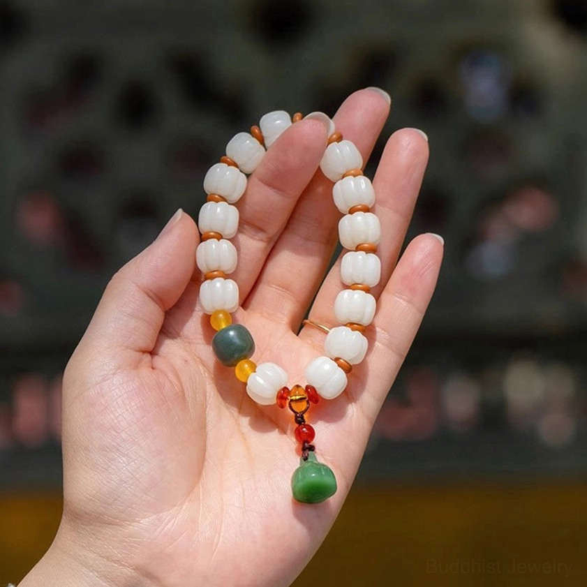 Bodhi seed agate bracelet in palm showing lotus pod pendant and natural bead texture
