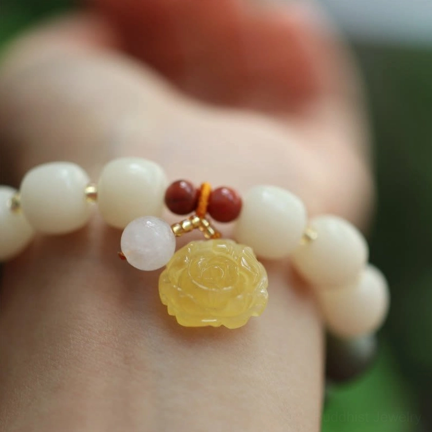 Side wrist view of Buddhist meditation bracelet with rose pendant and red agate spacers for spiritual grounding